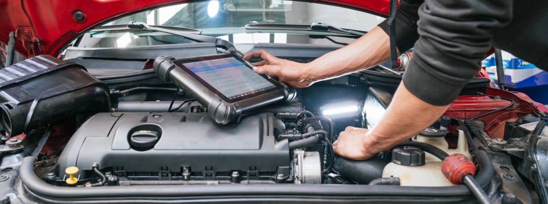 Tech working on vehicle